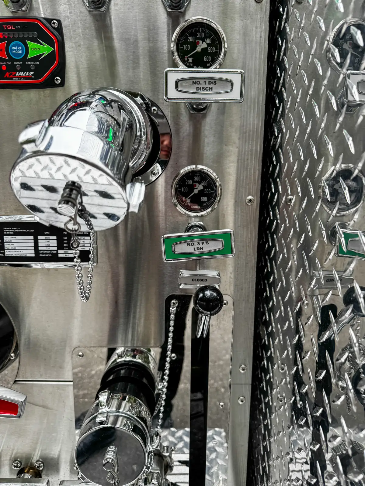 Pump panel close-up with large intake cap and adjacent valve controls.